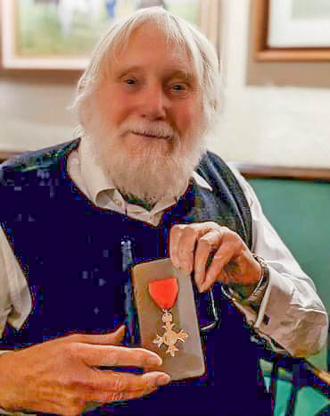 Photo of John Mills MBE with his award